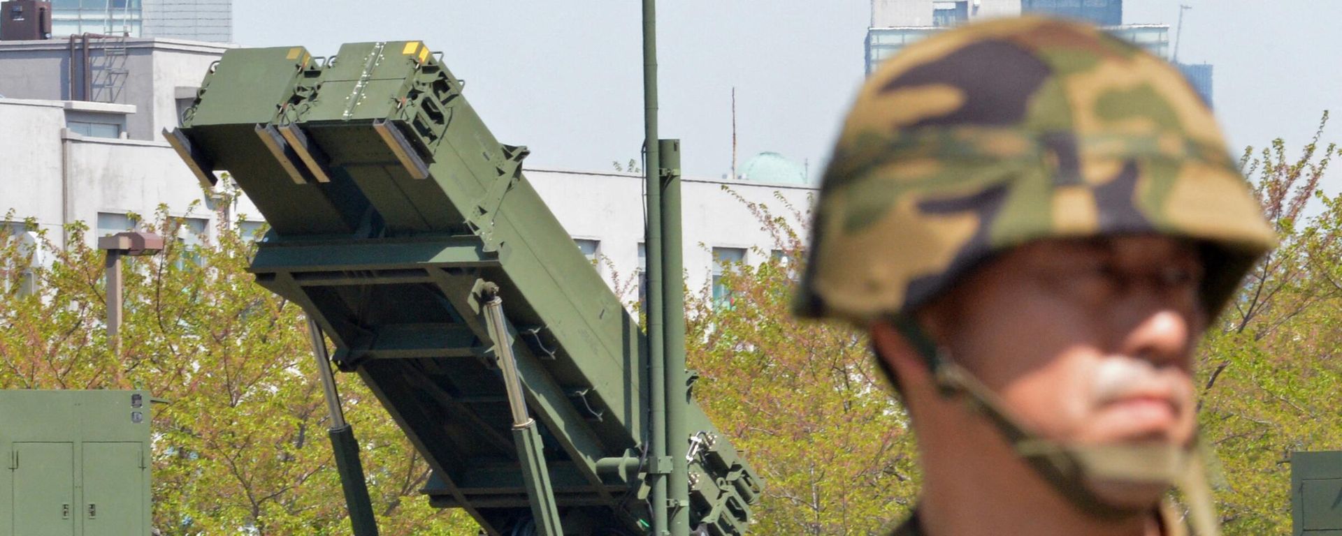 A soldier (R) of Japan's Ground Self Defence Force looks on as Japanese Foreign Minister Fumio Kishida (unseen in this picture) inspected Patriot Advanced Capability-3 (PAC-3) missile launchers at the Defence Ministry headquarters in Tokyo on April 13, 2013. A soldier (R) of Japan's Ground Self Defence Force looks on as Japanese Foreign Minister Fumio Kishida (unseen in this picture) inspected Patriot Advanced Capability-3 (PAC-3) missile launchers at the Defence Ministry headquarters in Tokyo on April 13, 2013. - Sputnik International, 1920, 03.05.2024