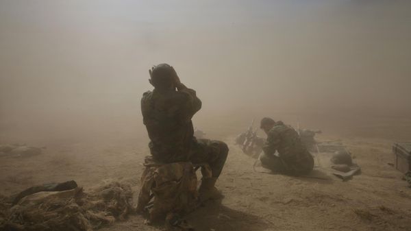 Afghan National Army soldiers protect their faces from flying dust as a helicopter takes off from a U.S. army base in the Pech Valley of Afghanistan's Kunar province Sunday, Nov. 1, 2009 - Sputnik International