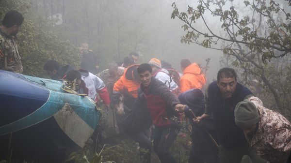 Rescue team members work at the crash site of a helicopter carrying Iranian President Ebrahim Raisi in Varzaghan, in northwestern Iran, on May 20, 2024.  - Sputnik International