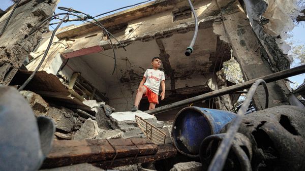 A Palestinian boy stands on the rubble of a destroyed house in Nuseirat following Israeli bombardment overnight on May 23, 2024, amid continuing battles between Israel and Hamas in the Gaza Strip. - Sputnik International