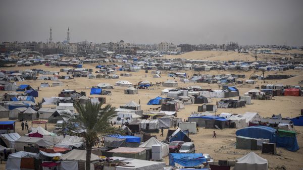 Palestinians displaced by the Israeli air and ground offensive on the Gaza Strip walk through a makeshift tent camp in Rafah, Gaza, Friday, May 10, 2024. (AP Photo/Abdel Kareem Hana) - Sputnik International