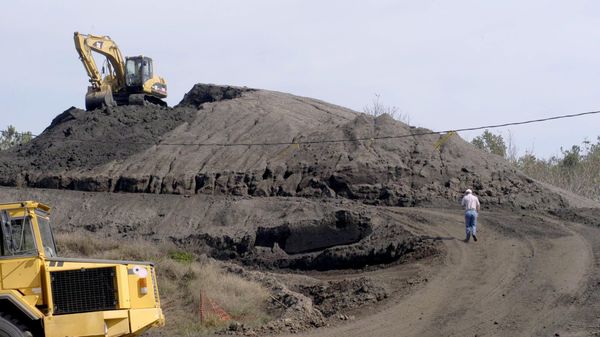 Following lunch Tuesday, Oct. 21, 2003, an employee returns to his job on the excavator at the top of the hill of cleaned dirt at the Warren County PCB Landfill Detroxification Project near Warrenton, N.C.  - Sputnik International