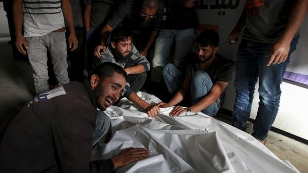 Palestinians mourn over the bodies of relatives killed in an Israeli airstrike, at a morgue in Rafah, Gaza Strip, Monday, May 27, 2024. Palestinian health workers said Israeli airstrikes Sunday killed at least 35 people sheltering in a tent camp for displaced people. Israel's army confirmed the strike and said it hit a Hamas installation and killed two senior Hamas militants. (AP Photo/Jehad Alshrafi) - Sputnik International