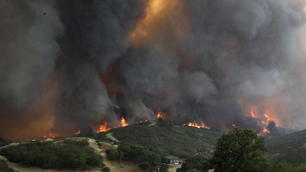 An advancing wildfire crests over a ridge Tuesday, July 31, 2018, in Lakeport, Calif - Sputnik International