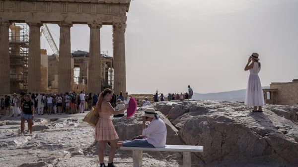 A tourist uses a hand fan to cool down another one sitting on a bench in front of the Parthenon at the ancient Acropolis, in Athens, Wednesday, June 12, 2024. The ancient site was closed to the public for five hours due to a heat wave that pushed temperatures to 39 degrees Celsius (102 Fahrenheit) in the capital and even higher in parts of central Greece. - Sputnik International