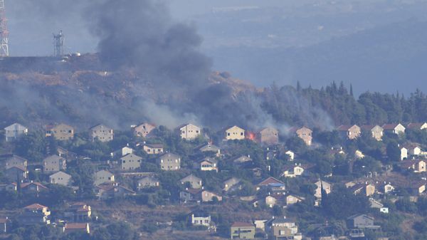 Fires and black smoke rise from between the houses of the northern Israeli border town of Metula which hit by Hezbollah shelling, is seen from the Lebanese side of the Lebanese town of Marjayoun, Lebanon, Saturday, June 22, 2024.  - Sputnik International