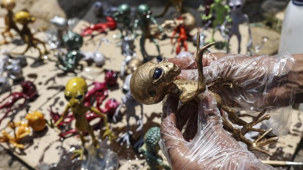 A craftsman holds an alien toy during an Astronomy Festival that brings together astronomy professionals and enthusiasts to share knowledge about the universe in Villa de Leyva, Colombia, Saturday, March 16, 2024 - Sputnik International