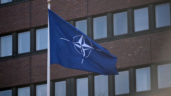 The NATO flag flutters in the wins after it was hoisted in front of the headquarters of Sweden's Armed Forces in Stockholm on March 11, 2024, to mark the entry of Sweden in the alliance. - Sputnik International