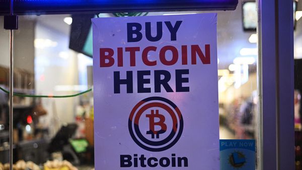 A sign offering Bitcoin for sale is seen in a store window in Hollywood, California, October 20, 2022.  - Sputnik International