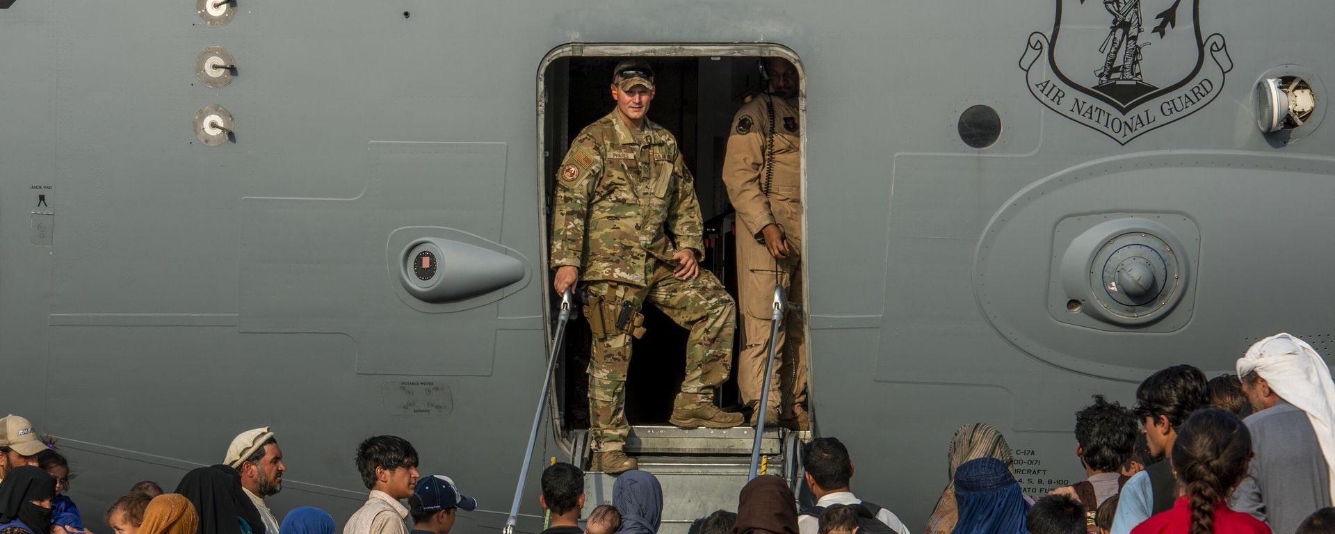 In this Aug. 22, 20121, image provided by the US Air Force, service members prepare to board evacuees onto a C-17 Globemaster lll on Sunday, Aug. 22, 2021, at Al Udeid Air Base, Qatar In this Aug. 22, 20121, image provided by the US Air Force, service members prepare to board evacuees onto a C-17 Globemaster lll on Sunday, Aug. 22, 2021, at Al Udeid Air Base, Qatar - Sputnik International, 1920, 02.09.2024