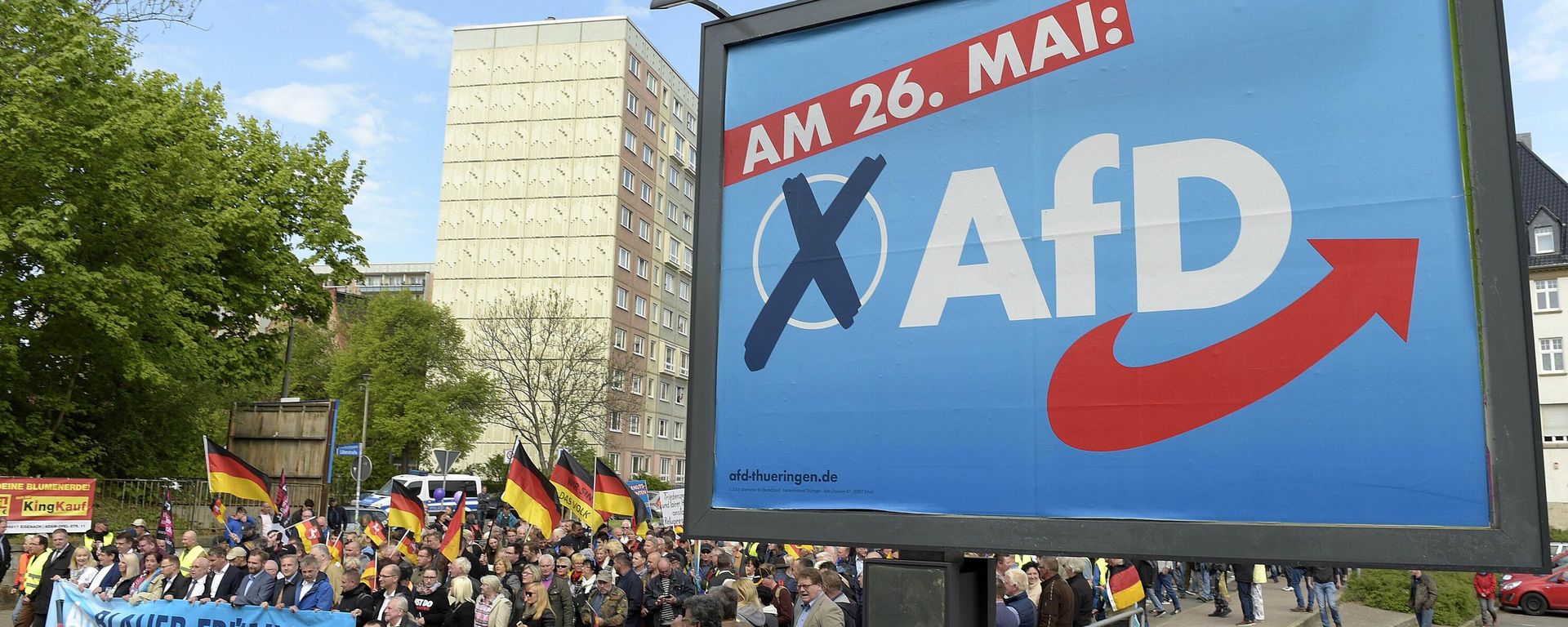 File picture taken May 1, 2019 shows AfD supporters walkin along a party elections poster in Erfurt, Germany. German media outlets are reporting the country's domestic intelligence agency has put the opposition Alternative for Germany party under observation under suspicion of extreme right sympathies File picture taken May 1, 2019 shows AfD supporters walkin along a party elections poster in Erfurt, Germany. German media outlets are reporting the country's domestic intelligence agency has put the opposition Alternative for Germany party under observation under suspicion of extreme right sympathies - Sputnik International, 1920, 04.09.2024