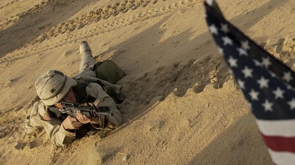 This Jan. 25, 2003 file photo shows an US soldier lying with his rifle in front of an American flag that hangs from a Humvee during live fire exercises in the Kuwaiti desert south of Iraq. - Sputnik International