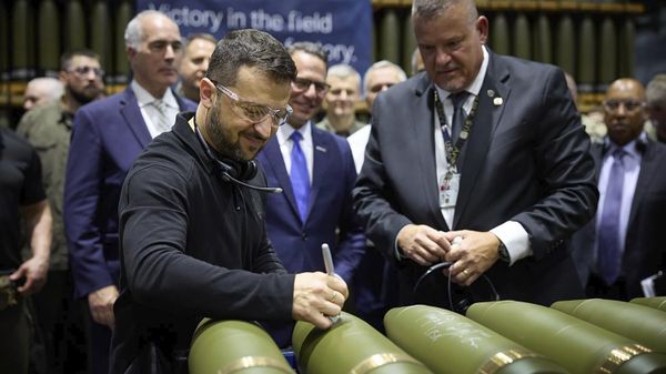 In this image provided by the Office of the Ukrainian Presidency, Ukrainian President Volodymyr Zelenskyy, left, is watched by Rich Hansen, the commander's representative for the Scranton Army Ammunition Plant, while signing military ordnance in Scranton, Pa., Sunday, Sept. 22, 2024. - Sputnik International