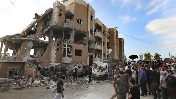 People gather next of a destroyed building hit by an Israeli airstrike, in Barja village, south of Beirut, Lebanon, Saturday, Oct. 12, 2024.  - Sputnik International