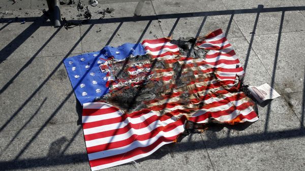 A burnt copy of a United Stated flag lays in front of the Palace of La Moneda, after it was lit by a single man to protest against the visit of US Vice President Mike Pence, in Santiago, Chile, Wednesday, Aug. 16, 2017 A burnt copy of a United Stated flag lays in front of the Palace of La Moneda, after it was lit by a single man to protest against the visit of US Vice President Mike Pence, in Santiago, Chile, Wednesday, Aug. 16, 2017 - Sputnik International