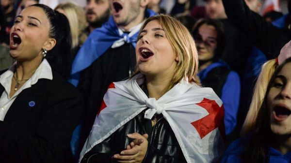 Supporters of Georgia's ruling Georgian Dream party celebrate the party's victory in parliamentary elections at a square outside the Georgian Dream office in Tbilisi, Georgia. - Sputnik International