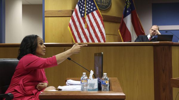 Fulton County District Attorney Fani Willis gestures while testifying as Fulton County Superior Judge Scott McAfee presides  during a hearing on the Georgia election interference case, Thursday, Feb. 15, 2024, in Atlanta. The hearing is to determine whether Willis should be removed from the case because of a relationship with Nathan Wade, special prosecutor she hired in the election interference case against former President Donald Trump. - Sputnik International