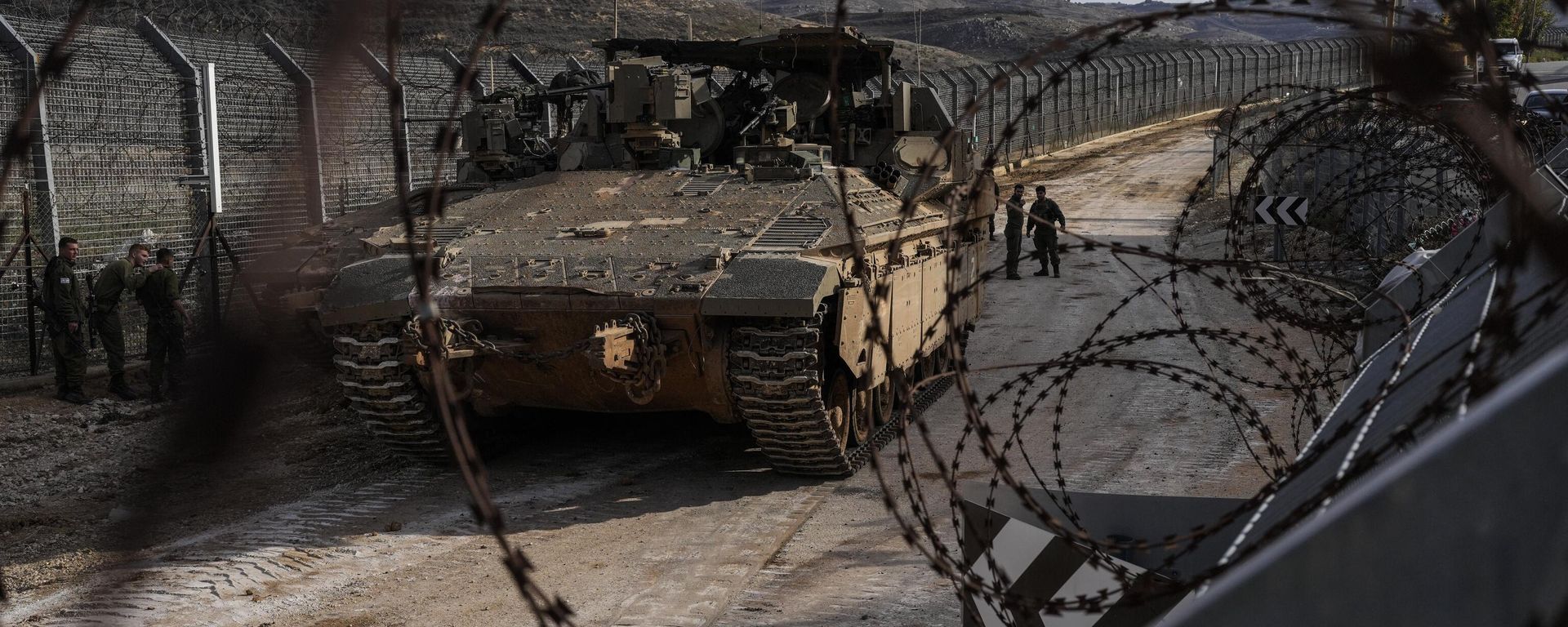 Israeli soldiers stand next to armored vehicles parked near the so-called Alpha Line that separates the Israeli-annexed Golan Heights from Syria, in the town of Majdal Shams, Monday, Dec. 9, 2024. Israeli soldiers stand next to armored vehicles parked near the so-called Alpha Line that separates the Israeli-annexed Golan Heights from Syria, in the town of Majdal Shams, Monday, Dec. 9, 2024. - Sputnik International, 1920, 10.12.2024