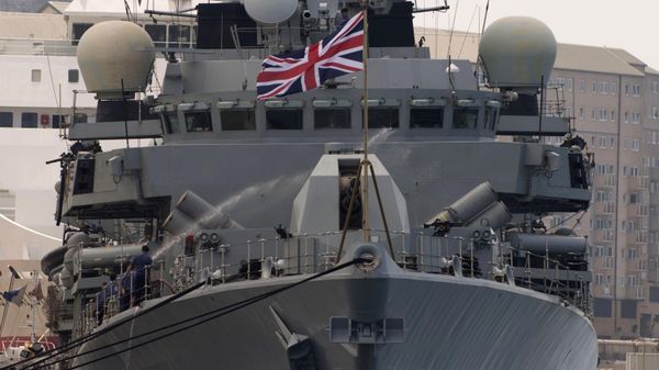 A crew member uses a water hose onboard Britain's Royal Navy warship HMS Westminster in Gibraltar, Monday, Aug. 19, 2013 after the ship arrived for what Britain's government said was a planned naval exercise in the Mediterranean - Sputnik International