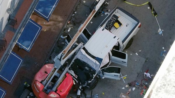A black flag with white lettering lies on the ground rolled up behind a pickup truck that a man drove into a crowd on Bourbon Street in New Orleans, killing and injuring a number of people, early Wednesday morning, Jan. 1, 2025. - Sputnik International