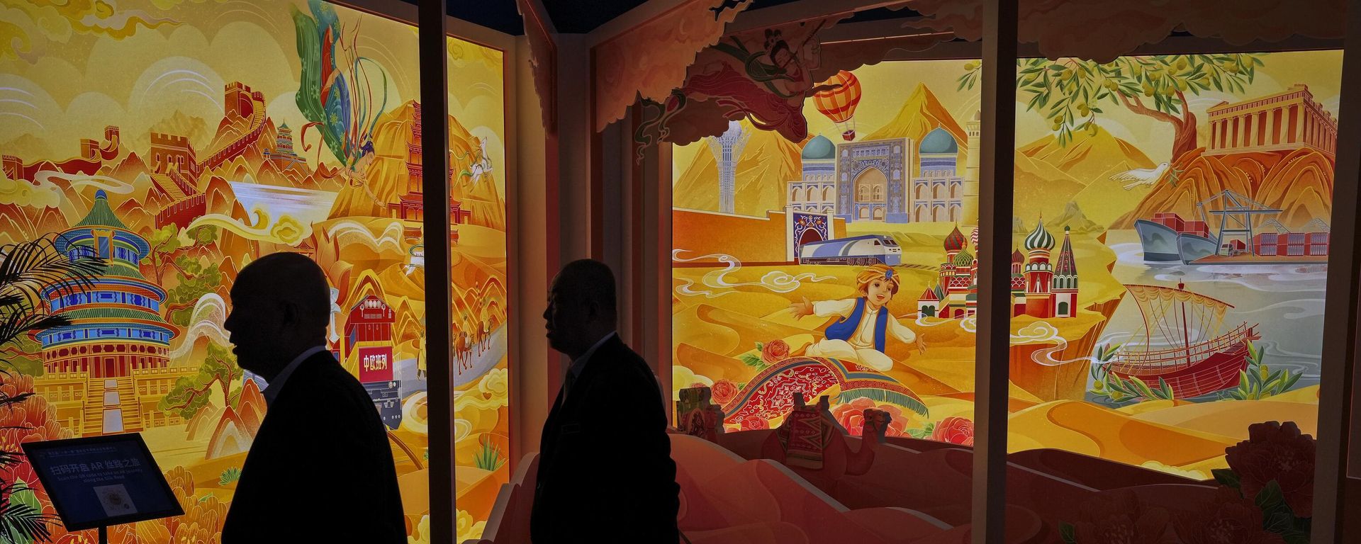 Attendees are silhouetted as they pass by an art display depicting China's Belt and Road Initiative at the China National Convention Center in Beijing, Wednesday, Oct. 18, 2023. Attendees are silhouetted as they pass by an art display depicting China's Belt and Road Initiative at the China National Convention Center in Beijing, Wednesday, Oct. 18, 2023. - Sputnik International, 1920, 16.02.2025