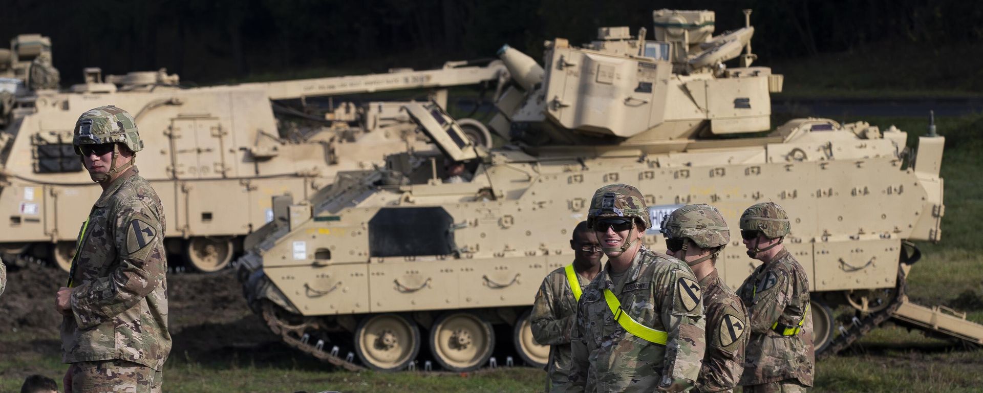 Members of the US Army's 1st Armoured Battalion of the 9th Regiment, 1st Division from Fort Hood in Texas rest next to Bradley Infantry Fighting Vehicles after arriving at the Pabrade railway station some 50 km (31 miles) north of the capital Vilnius, Lithuania, Monday, Oct. 21, 2019. - Sputnik International, 1920, 19.01.2026