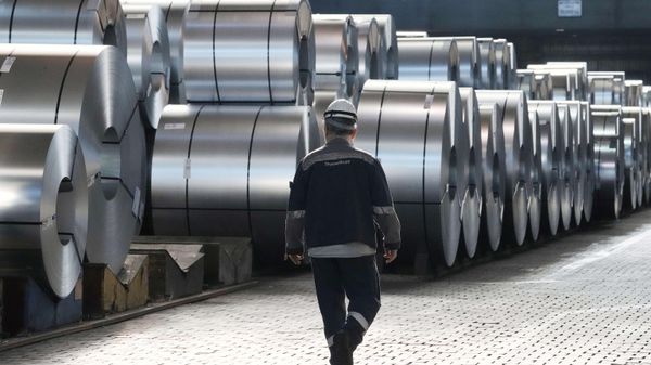A steel worker walks beside steel coils during a visit of EU Commissioner for Prosperity and Industrial Strategy Stephane Sejourne at the Thyssenkrupp steelworks in Duisburg, Germany, on March 20, 2025.  - Sputnik International