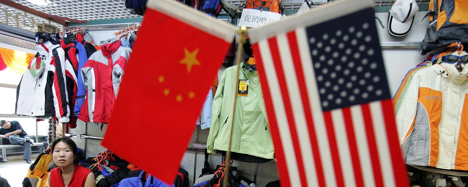 Chinese vendors at a clothing stall wait near Chinese and US flags for customers in Beijing, China, Tuesday, Sept 6, 2005. Chinese vendors at a clothing stall wait near Chinese and US flags for customers in Beijing, China, Tuesday, Sept 6, 2005. - Sputnik International, 1920, 22.06.2026