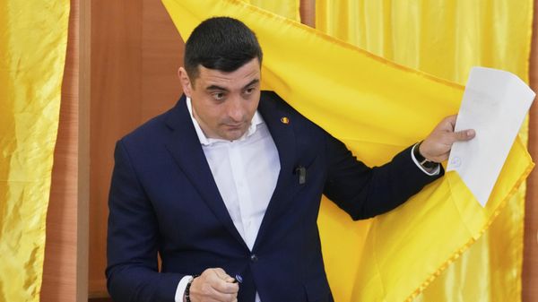 Presidential candidate George Simion exits a voting cabin before casting his vote in the first round of the presidential election redo in Mogosoaia, Romania, Sunday, May 4, 2025.  - Sputnik International
