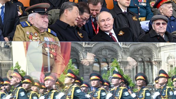 Presidents Putin and Xi and veterans look on as troops march past a protective glass barrier during Moscow's parade dedicated to the 80th anniversary of victory in the Great Patriotic War, Friday, May 9, 2025. - Sputnik International
