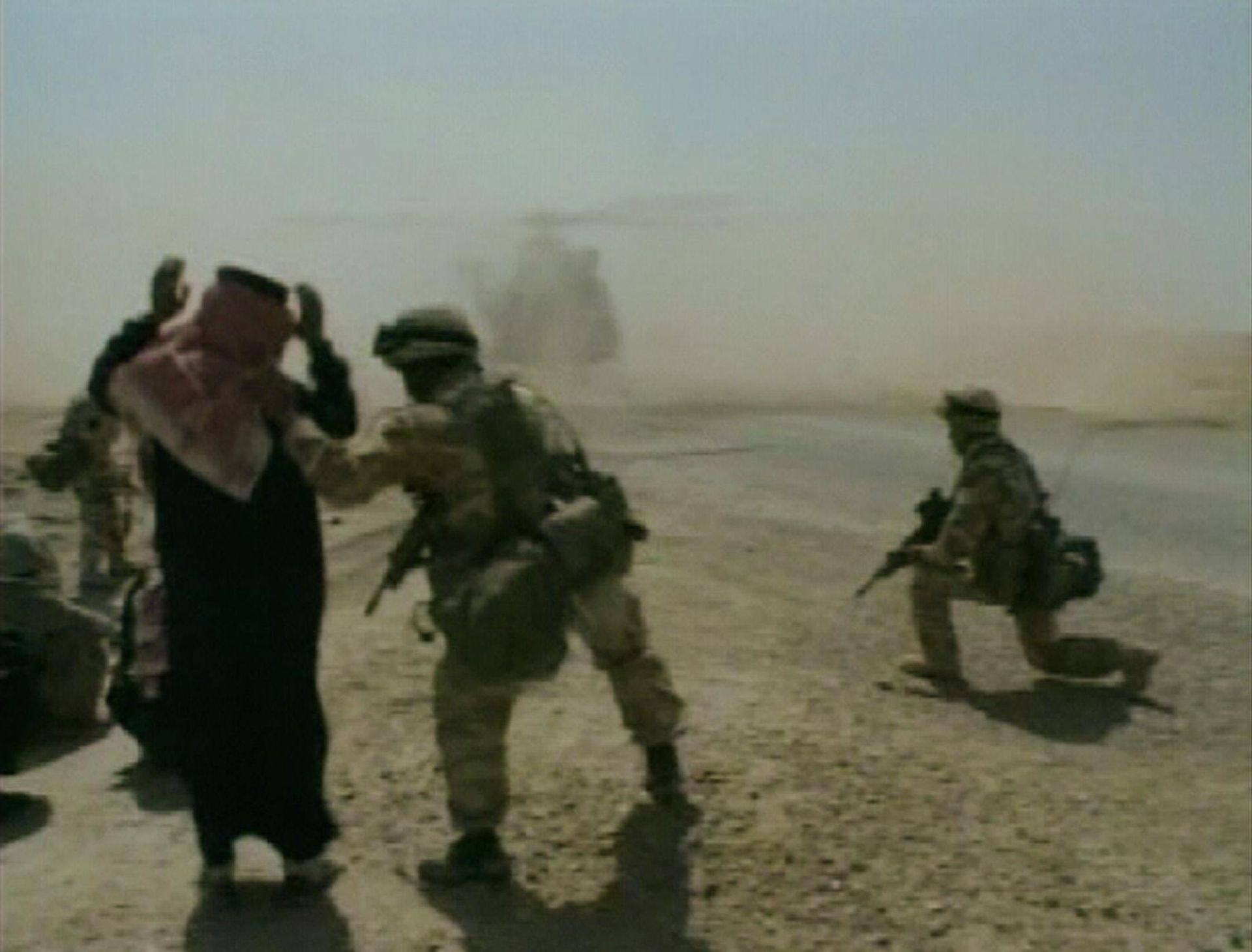 In this image taken from video, a British soldier directs an Iraqi to kneel, while an RAF Puma helicopter lands, Thursday, April 3, 2003, during patrols around Nasiriyah, Iraq.  - Sputnik International, 1920, 12.05.2025