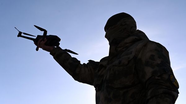 A man launches a drone  - Sputnik International