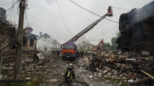Rescue workers extinguish a fire of a building destroyed by a strike in a village in Kiev region, Sunday, May 25, 2025. - Sputnik International
