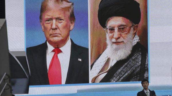 A man walks by a huge screen showing U.S. President Donald Trump, left, and Iranian Supreme Leader Ayatollah Ali Khamenei, in Tokyo, Wednesday, Jan. 8, 2020. Iran struck back at the United States early Wednesday for killing a top Revolutionary Guards commander, firing a series of ballistic missiles at two military bases in Iraq housing American troops in a major escalation between the two longtime foes. (AP Photo/Koji Sasahara) - Sputnik International