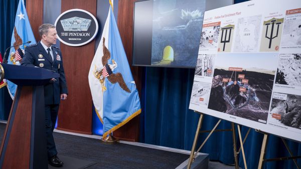 Joint Chiefs Chairman Gen. Dan Caine watches a test video of the ordinance used in the attack on the Iranian Fordow Fuel Enrichment Plant during a news conference at the Pentagon, Thursday, June 26, 2025 in Washington.  - Sputnik International