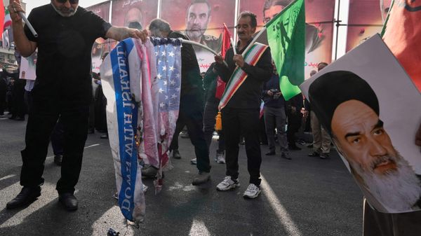 People burn the representations of the U.S. and Israeli flags as a poster of the late Iranian revolutionary founder Ayatollah Khomeini is held at right during the funeral ceremony of Iranian armed forces generals, nuclear scientists and their family members killed in a 12-day war with Israel, in Tehran, Iran, Saturday, June 28, 2025. People burn the representations of the U.S. and Israeli flags as a poster of the late Iranian revolutionary founder Ayatollah Khomeini is held at right during the funeral ceremony of Iranian armed forces generals, nuclear scientists and their family members killed in a 12-day war with Israel, in Tehran, Iran, Saturday, June 28, 2025. - Sputnik International