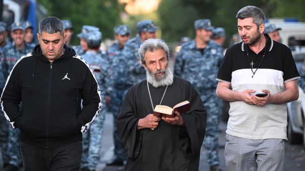 Priest Grigor Hovhannisyan reads a prayer outside a courthouse in Yerevan. A criminal case has been opened against Archbishop of Shirak of the Armenian Apostolic Church Mikael Ajapakhian, who is accused of publicly calling for the seizure of power, violation of territorial integrity, renunciation of sovereignty and violent overthrow of the constitutional order. On the night of June 28, Mikael Ajapakhian was arrested by a court decision for two months.
 - Sputnik International