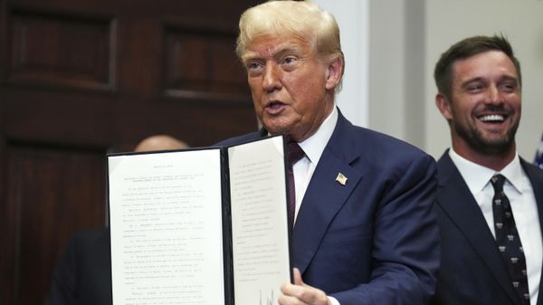 President Donald Trump holds up a signed executive order restarting the Presidential Fitness Test in public schools as professional golfer Bryson DeChambeau looks on, Thursday, July 31, 2025, in the Roosevelt Room of the White House in Washington - Sputnik International