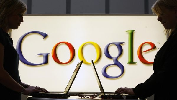 In this April 17, 2007 file photo, exhibitors work on laptop computers in front of an illuminated sign of the Google logo at the industrial fair Hannover Messe in Hanover, Germany. - Sputnik International