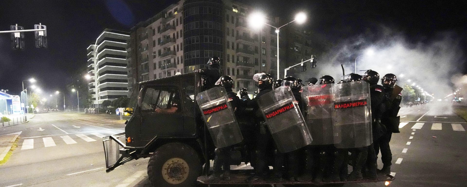 Serbian gendarmerie officers ride on a vehicle after clearing people blocking a street during an anti-government protest in Belgrade, Serbia, Saturday, Aug. 16, 2025. (AP Photo/Darko Vojinovic) - Sputnik International, 1920, 17.08.2025