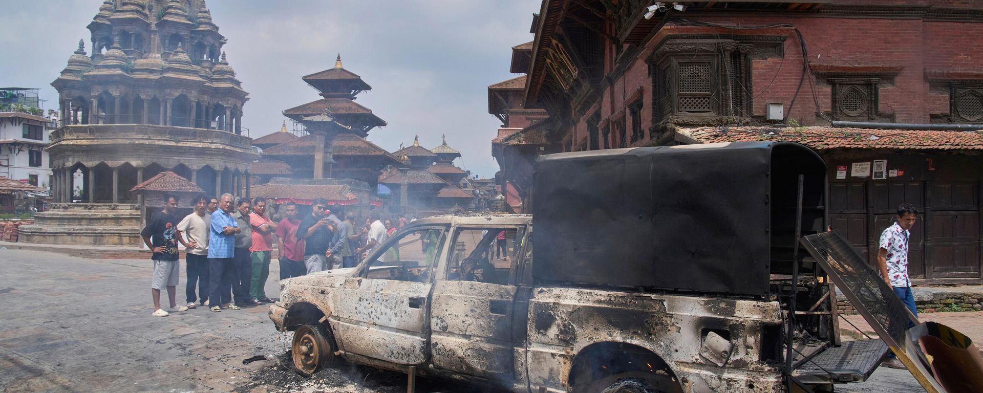 People look at a burnt police vehicle during protests against social media ban and corruption in Kathmandu, Nepal, Tuesday, Sept. 9, 2025.  - Sputnik International, 1920, 09.09.2025