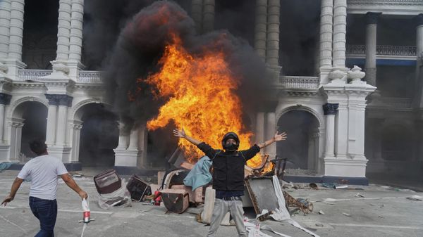 Protesters celebrate at the Singha Durbar, the seat of Nepal's government's various ministries and offices, after it was set on fire during a protest against social media ban and corruption in Kathmandu, Nepal, Tuesday, Sept. 9, 2025.  - Sputnik International