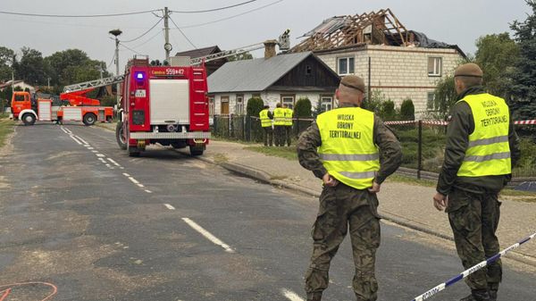 Firefighters and territorial defence officers stand close to the destroyed roof of a house after drones violated Polish airspace in Wyryki near Lublin, Poland, Thursday, Sept. 11, 2025.  - Sputnik International