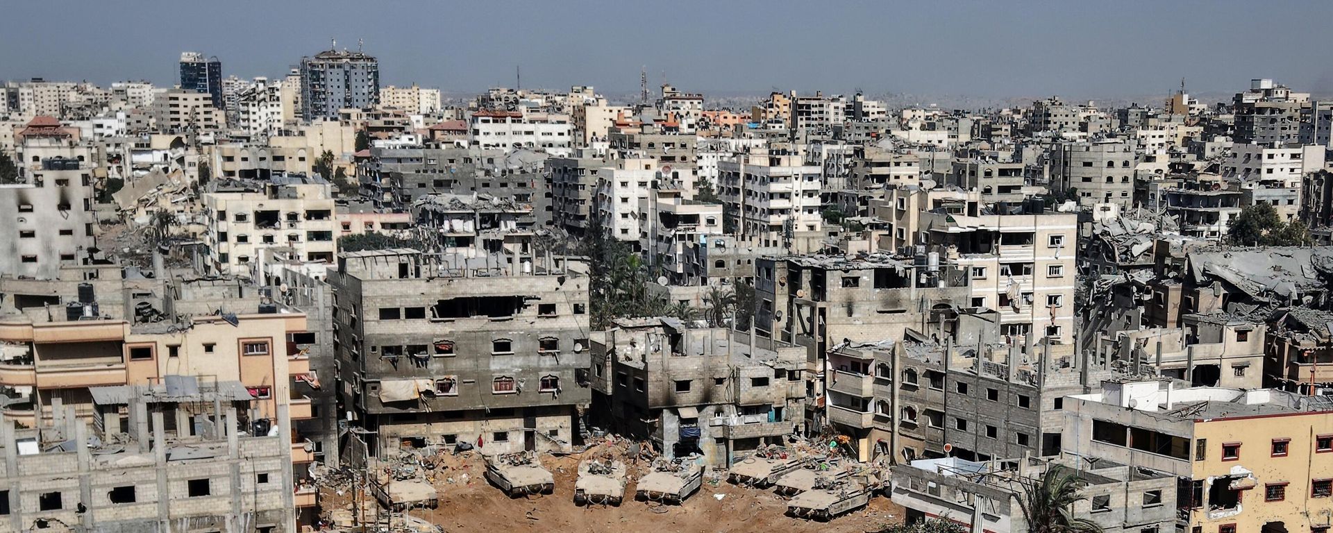 This aerial picture taken during a media tour organised by the Israeli army, shows Israeli army tanks and armoured personnel carriers stationed amid war-damaged buildings in the vicinity of the Jordanian Field Hospital in Gaza City, Friday, Oct. 3, 2025. This aerial picture taken during a media tour organised by the Israeli army, shows Israeli army tanks and armoured personnel carriers stationed amid war-damaged buildings in the vicinity of the Jordanian Field Hospital in Gaza City, Friday, Oct. 3, 2025. - Sputnik International, 1920, 12.12.2025