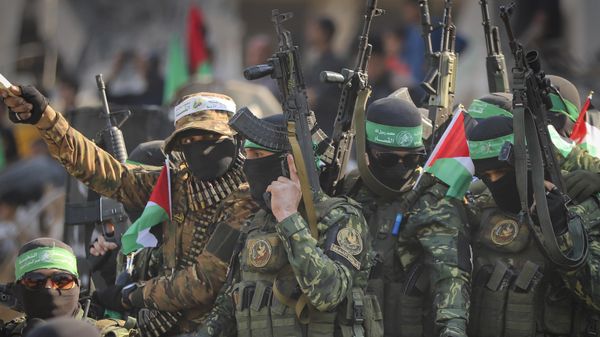 Hamas fighters arrive in a pick-up truck to the site of the hand over of hostage Agam Beger to the Red Cross at the Jabalya refugee camp in Gaza City, Thursday Jan. 30, 2025 - Sputnik International