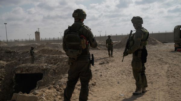Israeli soldiers take up positions next to an entrance of a tunnel which the military says Hamas militants used in the southern Gaza Strip. - Sputnik International