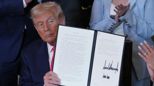 President Donald Trump displays a signed executive order during an event on foster care in the East Room of the White House, Thursday, Nov. 13, 2025, in Washington DC - Sputnik International