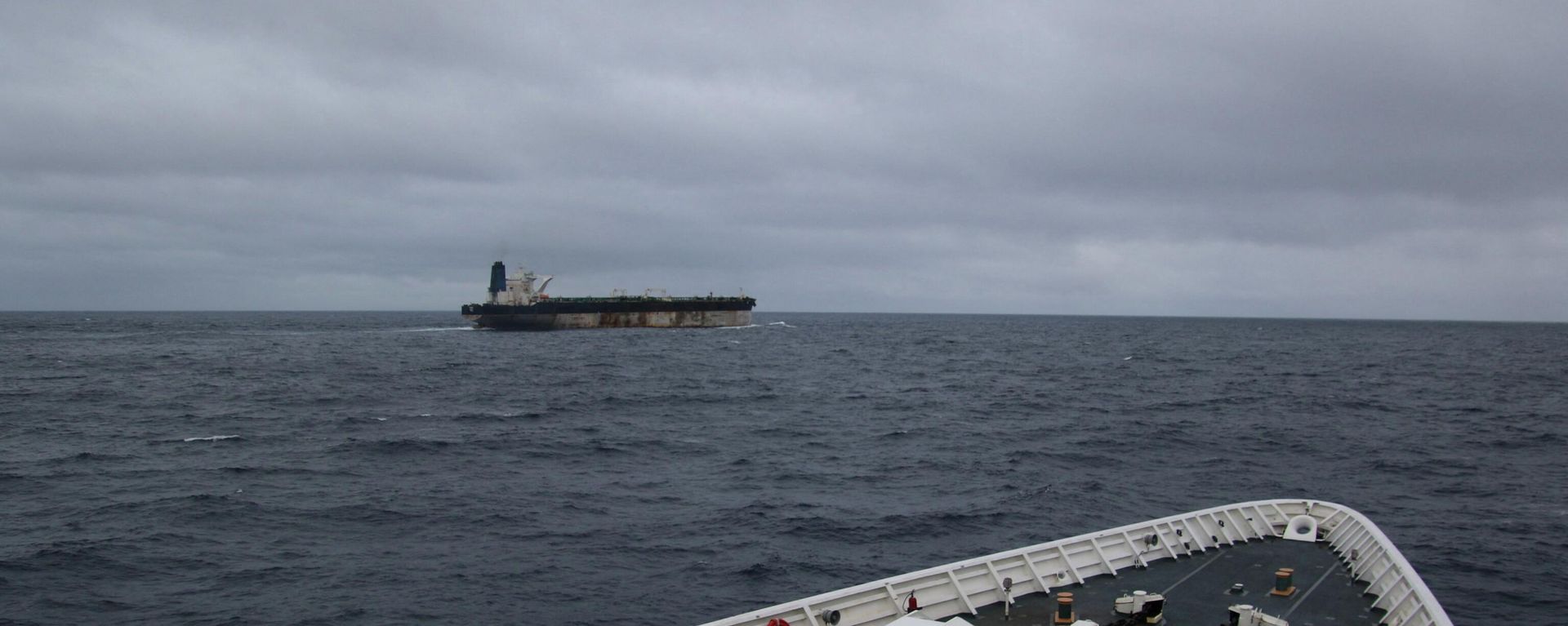 A handout image of the ship Marinera (Ex-Bella 1) seen in the distance, released on January 7, 2026.  US EUROPEAN COMMAND via X/Handout via REUTERS    - Sputnik International, 1920, 08.01.2026