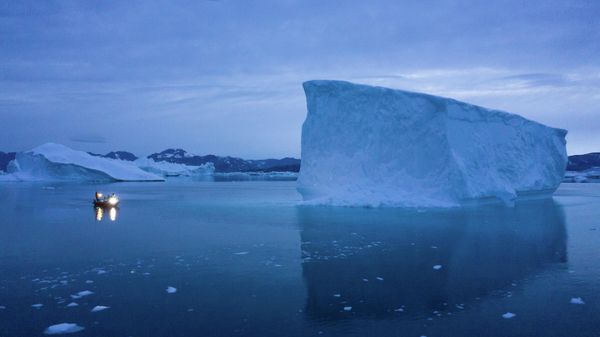 In this Aug. 15, 2019, photo, a boat navigates at night next to icebergs in eastern Greenland.   - Sputnik International