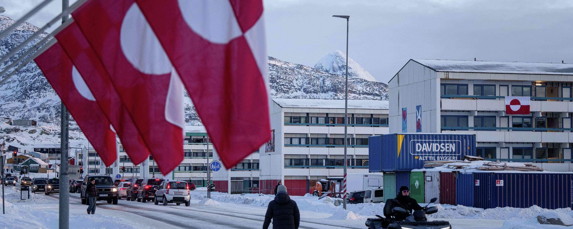 A man rides by on a quad bike past a row of Greenlandic national flags in Nuuk, Greenland, Wednesday, Jan. 14, 2026. - Sputnik International, 1920, 15.01.2026